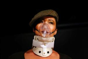 A model wearing an oxygen mask, walks along a make-shift catwalk during a fashion show organized by environmental group Greenpeace titled 'Toxic Threads - The Big Fashion Stitch-Up', in Beijing November 20, 2012. (photo courtesy of REUTERS/David Gray)