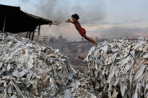 The unglamorous side to fashion: A child jumps on the leather luxury waste products as she plays in a tannery in Dhaka 