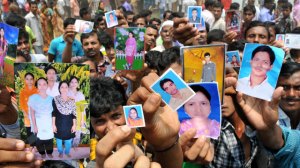 Bangladeshis show photos of missing relatives after building collapse